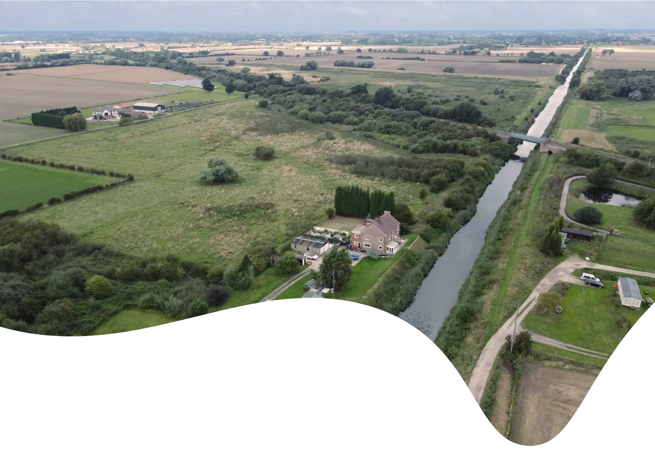 Aerial view of the Market Weighton Canal Trail masked into a fluid shape.